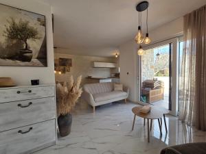 a living room with a white dresser and a couch at Guest house Noemi in Marčana