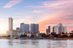 a city skyline with a river and buildings at Crowne Plaza Phnom Penh by IHG 金边皇冠假日酒店 Former VM Hotel in Phnom Penh