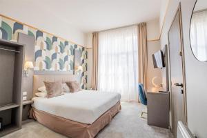 Postel nebo postele na pokoji v ubytování Best Western Hotel Saint Claude