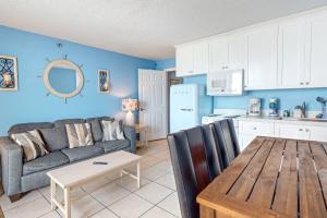 een keuken en een woonkamer met een bank en een tafel bij Daytona Harbour Beach Resort 213 in Seabreeze