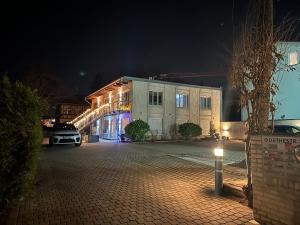 un edificio con un coche aparcado delante de él por la noche en Apartmenthaus Zeuthen, en Zeuthen