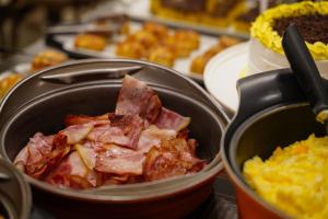a pot of food with bacon in it at Interclass Florianópolis in Florianópolis