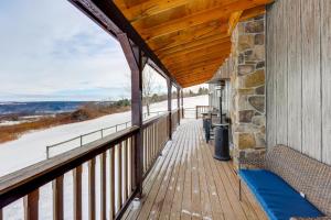 un portico coperto con una panchina su un edificio di Panoramic Upstate Views Tranquil Home on 70 Acres a Prattsburg