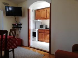 a view of a kitchen through a mirror at Apartmani Brkan in Donja Lastva +8 photos