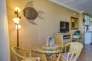 a dining room with a glass table and a television at Daytona Beach in Daytona Beach +23 photos