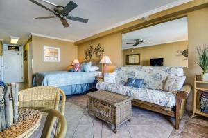 a living room with a couch and a bed at Daytona Beach in Daytona Beach