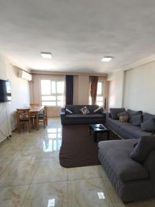 a living room with two couches and a table at Sheraton Palace 1 in Alexandria