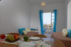 a living room with a table with fruit on it at Remi Apartments in Stalida