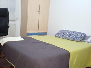 a bed with two pillows on top of it at Habitación in Oiartzun