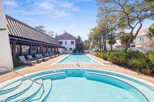 a swimming pool in the middle of a house at Sadie's Cottage in Rosemary Beach