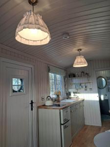 a kitchen with two lights hanging from the ceiling at Shepherds Hut Galway in Galway