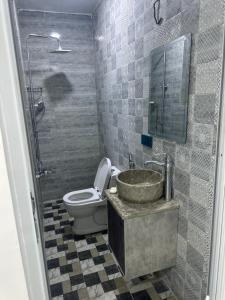 a bathroom with a sink and a toilet at Jadriya Serviced Residences in Baghdad +18 photos