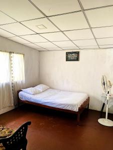 a bedroom with a bed and a sign on the ceiling at Villa Meleno in Weligama +32 photos
