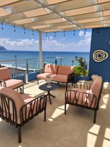 a patio with chairs and a view of the ocean at Mediterrâneo Madeira in São Vicente
