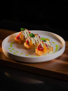 dos trozos de comida en un plato en una mesa en Ljubljana Resort Hotel & Camping, en Liubliana