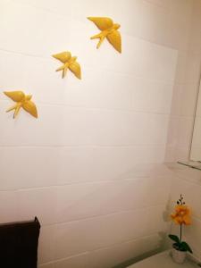 3 decoraciones de aves en la pared de un baño en Inn Golegã, en Golegã