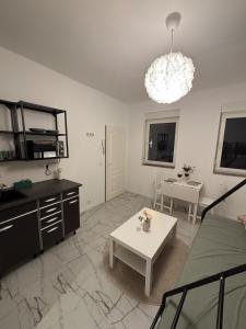a living room with a couch and a table at Cologne 20 min Tram 1 min, Top City Apartment in Niederdorla