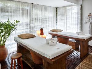 a room with two massage tables and a window at Santa Teresa Hotel Rio de Janeiro - MGallery Collection in Rio de Janeiro