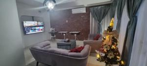 a living room with two couches and a christmas tree at 56 Archer Crescent Mainhouse in Durban