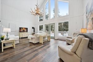 a living room with a couch and chairs and a fireplace at Whispering Dune Winter Retreat by Singing Sands in Tobermory