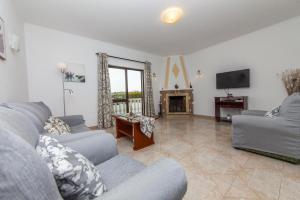 a living room with two couches and a tv at D02 - Carrob Street House in Lagos