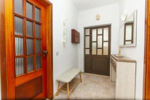 a room with a door and a stool next to a kitchen at D02 - Carrob Street House in Lagos +27 photos
