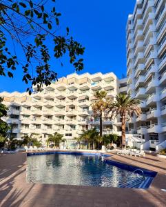 a large apartment building with a swimming pool in front of it at Las Americas 200A apartment in Costa de Adeje