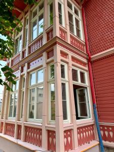 a red building with white windows on a street at SeeBlick Apt 7 Bałtyk Luxury Residence in Międzyzdroje +75 photos