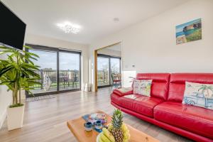 a living room with a red couch and a table at 2 Bed in Crackington Haven oc-h33817 in Crackington Haven