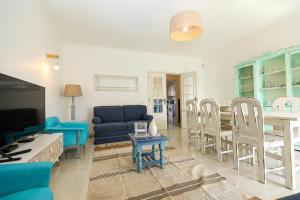 a living room with a blue couch and a table at C13 - Ameijeira Holiday Apartment in Lagos in Lagos