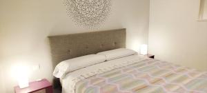 1 dormitorio con 1 cama, 2 mesitas de noche y 2 luces en Estudio - descanso y bienestar en La Punta, en Punta del Hidalgo