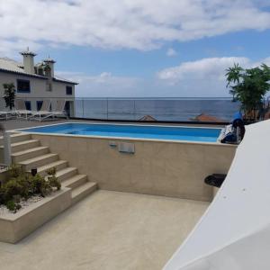 a swimming pool with a view of the ocean at Mediterrâneo Madeira in São Vicente +9 photos