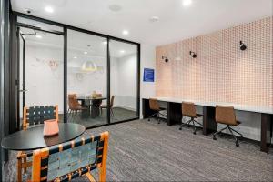 a conference room with a table and chairs and a table and a tablektop at Blueground Austin pool nr Walnut Creek ATX-258 in Austin +24 photos