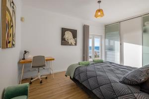 a bedroom with a bed and a desk and a chair at FozPanoramic in Foz do Arelho +44 photos