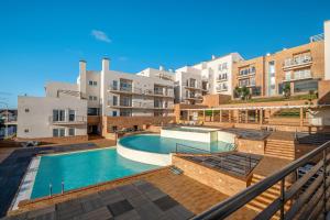 a swimming pool in front of some apartment buildings at FozPanoramic in Foz do Arelho