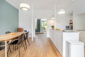 a kitchen and dining room with a wooden table and chairs at 3 Bed in Cyfronydd oc-e32742 in Llanfair Caereinion