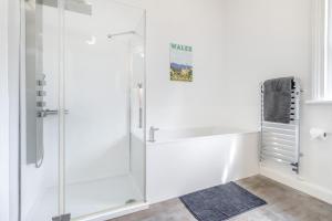 a white bathroom with a glass shower stall at 3 Bed in Cyfronydd oc-e32742 in Llanfair Caereinion +27 photos