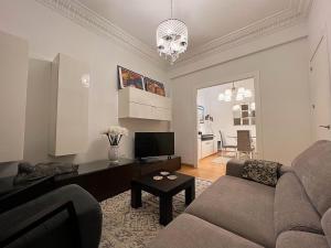 a living room with a couch and a television at Céntrico Apartamento con parking in A Coruña