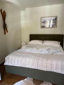 a bedroom with a large bed with white sheets at Maison Poluc - Chiaro di Luna in Champoluc +30 photos