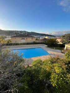een zwembad in de achtertuin van een huis bij Studio avec canapé lit 2 places dans pièce de vie et lit une place dans coin nuit in Saint-Mandrier-sur-Mer