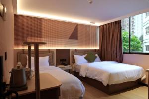 a hotel room with two beds and a window at Hotel 165 - Newly Renovated in Singapore
