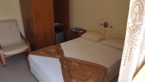 A bed or beds in a room at Hotel Lazareto