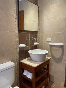 ein Badezimmer mit Waschbecken, Toilette und Spiegel in der Unterkunft Linda Vista en Adrogue in Adrogué