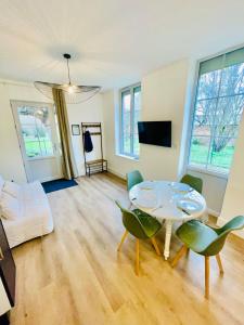 a living room with a table and chairs at Les Jardins Bas in Moulins