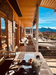 a table on a porch with a view of the mountains at Luxus Seaside Loft in Füssen