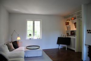 a living room with a couch and a window at Villa Hjortekær in Kongens Lyngby