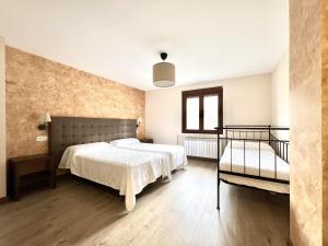 een slaapkamer met twee bedden en een raam bij La Casona de Omaña in Fasgar