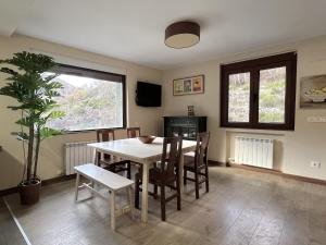 een eetkamer met een tafel en stoelen en een plant bij La Casona de Omaña in Fasgar