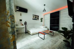 a bedroom with a bed and a table in it at Studio in Ploieşti