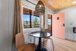 a dining room with a table and chairs and a window at The Boha Hotel in Lake Placid